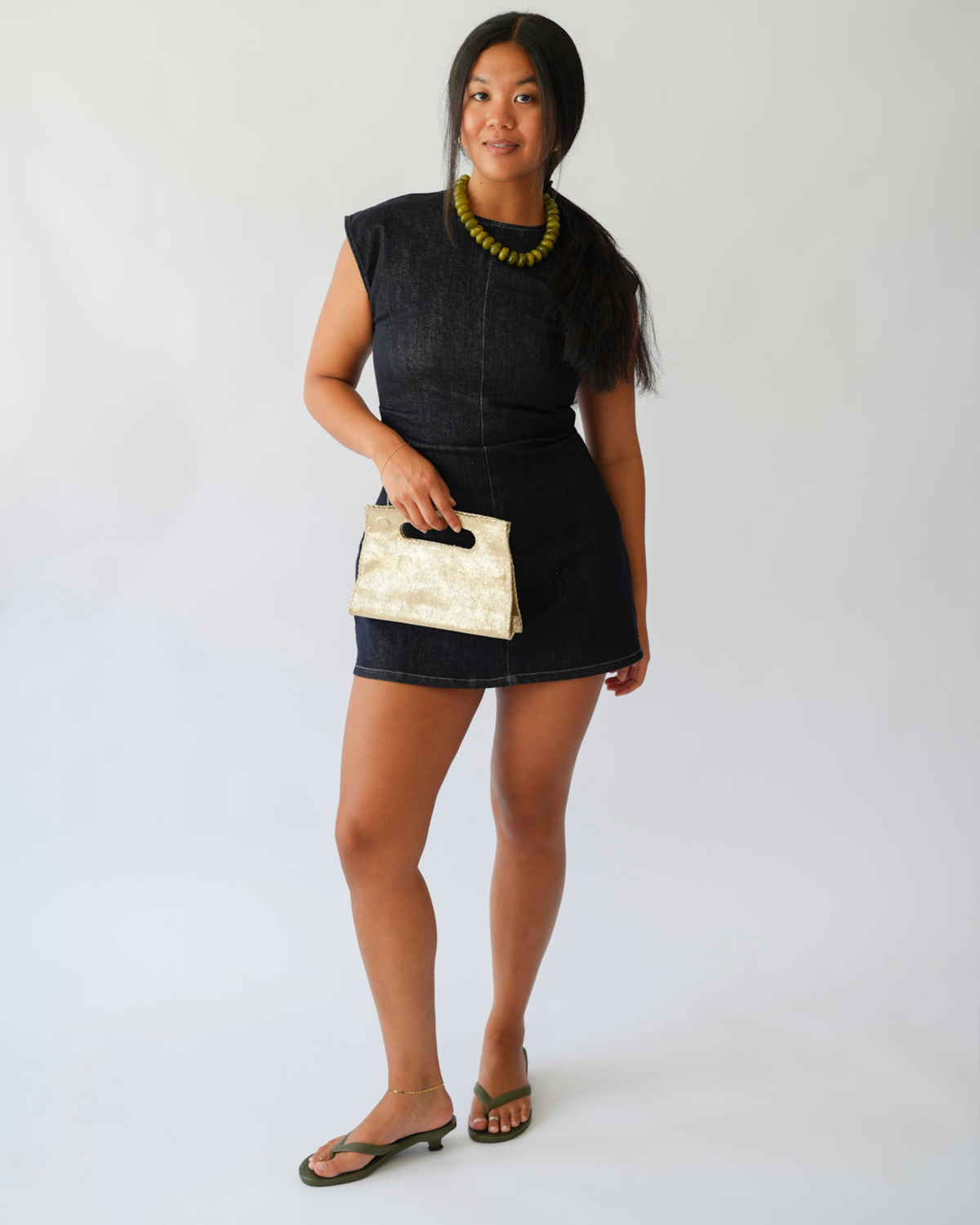 Girl holding a gold clutch